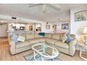 Spacious living room with a large sectional sofa, opening to the kitchen and dining area at 1513 Ocean Shore Blvd # 7B, Ormond Beach, FL 32176