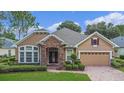 One story house with stone accents and a two car garage at 111 Asterbrooke Dr, Deland, FL 32724
