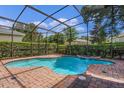 Inviting screened-in pool with a brick patio and fountain feature at 111 Asterbrooke Dr, Deland, FL 32724