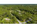 Panoramic aerial view featuring a home nestled within a dense forest setting, offering privacy and seclusion at 3428 Longleaf Rd, Ormond Beach, FL 32174