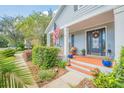 Inviting front porch with brick flooring, potted plants, and seating at 450 W Delaware Ave, Lake Helen, FL 32744