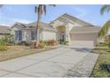 House exterior showcasing a light-colored facade, landscaping, and driveway at 341 Perfect Dr, Daytona Beach, FL 32124