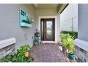 Inviting front entry with a decorative planter and brick walkway at 257 Ancona Ave, Debary, FL 32713