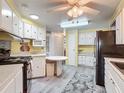 Well-lit kitchen with ample storage, modern appliances, and a cozy dining area at 824 Silver Oak Ave, The Villages, FL 32159