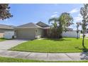 Front yard view of a single story house with a green lawn at 3435 Arabesque Dr, Deland, FL 32724