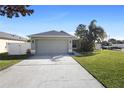 House exterior showcasing a driveway and attached garage at 3435 Arabesque Dr, Deland, FL 32724