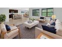 Bright living room boasts natural light, modern furniture, stylish decor, and an open-concept design at 317 Nowell Loop, Deland, FL 32724