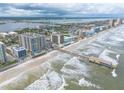 Aerial view of beachfront property with ocean, pier, and high-rise buildings at 3703 S Atlantic Ave # 501, Daytona Beach Shores, FL 32118