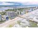 Breathtaking aerial view of beachfront condos, a fishing pier, and the scenic coastline, showcasing the coastal lifestyle at 3703 S Atlantic Ave # 501, Daytona Beach Shores, FL 32118