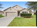 One-story house with a two-car garage and well-maintained lawn at 811 Grand Park Ct, Deland, FL 32724