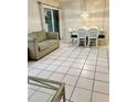 Dining area with white wicker chairs and tiled floors at 110 Cypress Woods Ct # 7D, Deltona, FL 32725