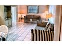 Bright living room featuring striped sofas and tiled floors at 110 Cypress Woods Ct # 7D, Deltona, FL 32725