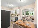 Bright kitchen and dining area with white cabinets and stainless steel appliances at 522 Powers Ave, Port Orange, FL 32127
