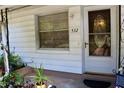 Close-up of home's front porch shows the front door with sidelight and house number at 532 W Wisconsin Ave, Deland, FL 32720