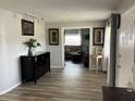 Inviting living room with wood-look flooring, decor, and a seamless flow to another room at 714 E Michigan Ave, Deland, FL 32724