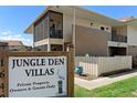 Jungle Den Villas sign, showing the property's entrance and attractive landscaping for a welcoming feel at 1640 Juno Trl # 205A, Astor, FL 32102