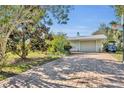 Brick paved driveway, garage, and basketball hoop in the backyard at 4430 Doris Dr, New Smyrna Beach, FL 32169
