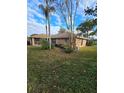 Brick house with partial view, landscaped yard at 507 Dade Ct, Deltona, FL 32725