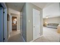 Hallway with light walls and tile floors leading to living room and bathroom at 4851 Orange Ave, Port Orange, FL 32127