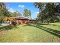 Expansive backyard with mature trees and a well-manicured lawn, ideal for outdoor activities at 1195 Glen Royal Ter, Deland, FL 32720