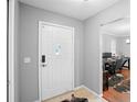 Welcoming entryway featuring a bright white door and view to home office, complemented by tiled flooring at 1195 Glen Royal Ter, Deland, FL 32720