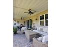 Spacious covered patio featuring brick pavers, comfortable seating and ceiling fans, perfect for outdoor living at 1227 Victoria Hills, Deland, FL 32724