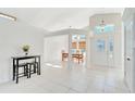 Bright entryway featuring soaring ceilings, a transom window, and decorative front door with sidelights at 3190 Lori Ct, Deltona, FL 32738