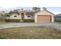 Single-story house with attached garage and landscaped front yard at 1267 Saxon Blvd, Deltona, FL 32725