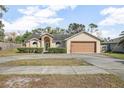 Single-story house with attached garage and landscaped front yard at 1267 Saxon Blvd, Deltona, FL 32725