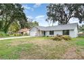 Spacious home featuring a large front yard and attached two-car garage at 779 Victoria E Cir, Ormond Beach, FL 32174