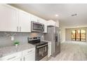 Updated kitchen featuring stainless steel appliances and granite countertops at 779 Victoria E Cir, Ormond Beach, FL 32174