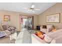 Bright living room featuring comfy seating and access to a patio at 2573 Delaware Rd, Deltona, FL 32738