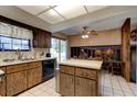 Wood kitchen cabinets, island, and adjacent dining space at 453 Merrimac Dr, Port Orange, FL 32127