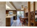 Kitchen features wood cabinets, an island, and a dining area at 453 Merrimac Dr, Port Orange, FL 32127