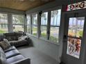 Inviting sunroom with large windows offering scenic views and comfortable seating area at 5178 Riverside Dr, Port Orange, FL 32127