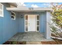 Inviting front entrance with a white door and gray tile flooring at 1275 Elkcam Blvd, Deltona, FL 32725
