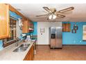 Galley style kitchen with stainless steel appliances and tile floor at 1391 San Carlos Ave, Deltona, FL 32738