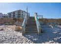 Wooden staircase leading to the beach at 2700 Ocean Shore Blvd # 317, Ormond Beach, FL 32176