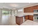 A well-appointed kitchen features granite countertops, stainless steel appliances, and an open layout to the living area at 430 Cypress Hills Way, Deland, FL 32724