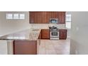 Spacious kitchen features granite countertops, stainless steel appliances, and ample cabinet space for storage at 430 Cypress Hills Way, Deland, FL 32724
