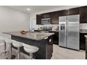 Well-equipped kitchen with stainless steel appliances and an island featuring bar seating at 635 Belgrove St, Debary, FL 32713