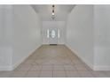 Bright foyer with tile flooring, high ceilings, and a decorative front door at 955 N Ridgewood Ave, Deland, FL 32720