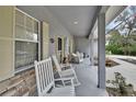 Spacious front porch with rocking chairs provides an inviting outdoor living space at 955 N Ridgewood Ave, Deland, FL 32720