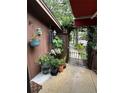 Cozy patio with hanging plants and gate leading to a walkway at 115 Cypress Pond Rd, Port Orange, FL 32128