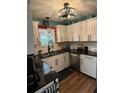 Modern kitchen with white cabinets and granite counters at 115 Cypress Pond Rd, Port Orange, FL 32128