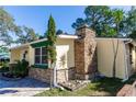 Side view of the house showcasing stone details and landscaping at 1649 W Waycross Cir, Deltona, FL 32725
