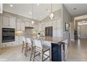 Bright kitchen features granite counters, stainless steel appliances, and a breakfast bar with pendant lighting at 2815 Sienna View Ter, New Smyrna Beach, FL 32168