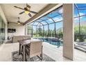 Inviting covered patio seating next to a screened-in pool and lush landscaping provides privacy at 2815 Sienna View Ter, New Smyrna Beach, FL 32168