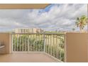 This condo's balcony overlooks the expansive green golf course under a cloudy sky at 3 Oceans West Blvd # 4A5, Daytona Beach Shores, FL 32118