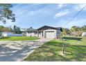 Ranch home with a large driveway and beautifully landscaped yard at 3070 Grand Ave, Deland, FL 32720